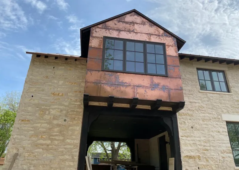 Copper metal panel facade on a stone building for Metal Roof Coating in Scottsbluff